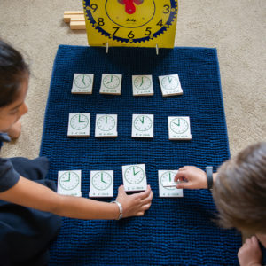students using Montessori clock activity